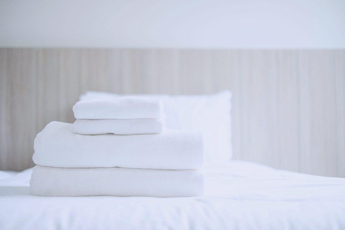 Stack of fresh white folded towels ready for the next guest